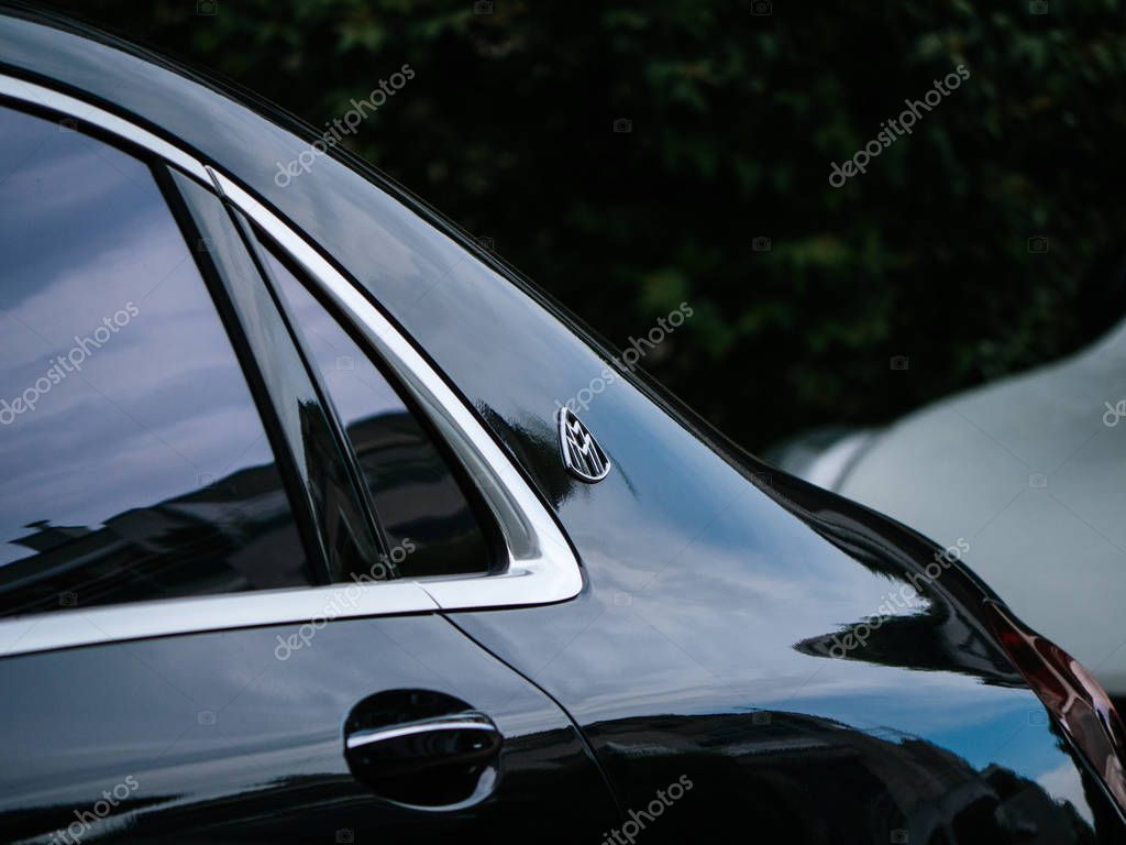 PARIS, FRANCE - MAY 21, 2018: Side view of Maybach Mercedes logotype on new luxury blue Mercedes-Maybach s600 4matic awd limousine parked on luxury street