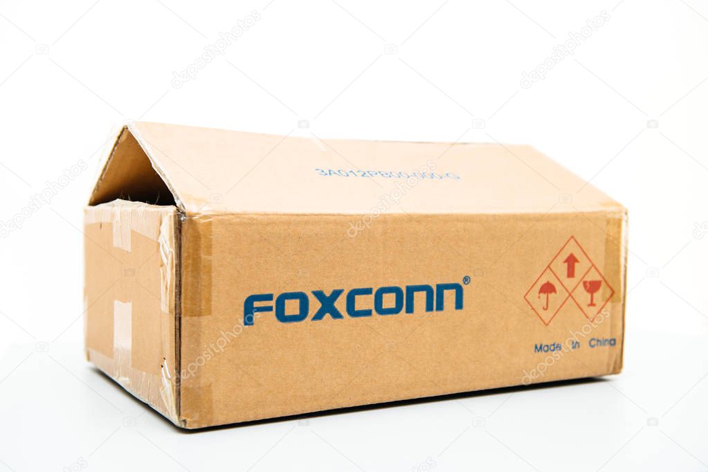 LONDON, UNITED KINGDOM - AUG 23, 2018: Side view of Foxconn cardboard delivery box with logotype on against white background containing spare parts for computers laptop and technology parts