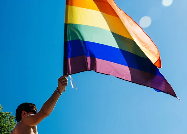 Kaukasische opgewonden homoseksuele man zwaaien Regenboogvlag op pride — Stockfoto