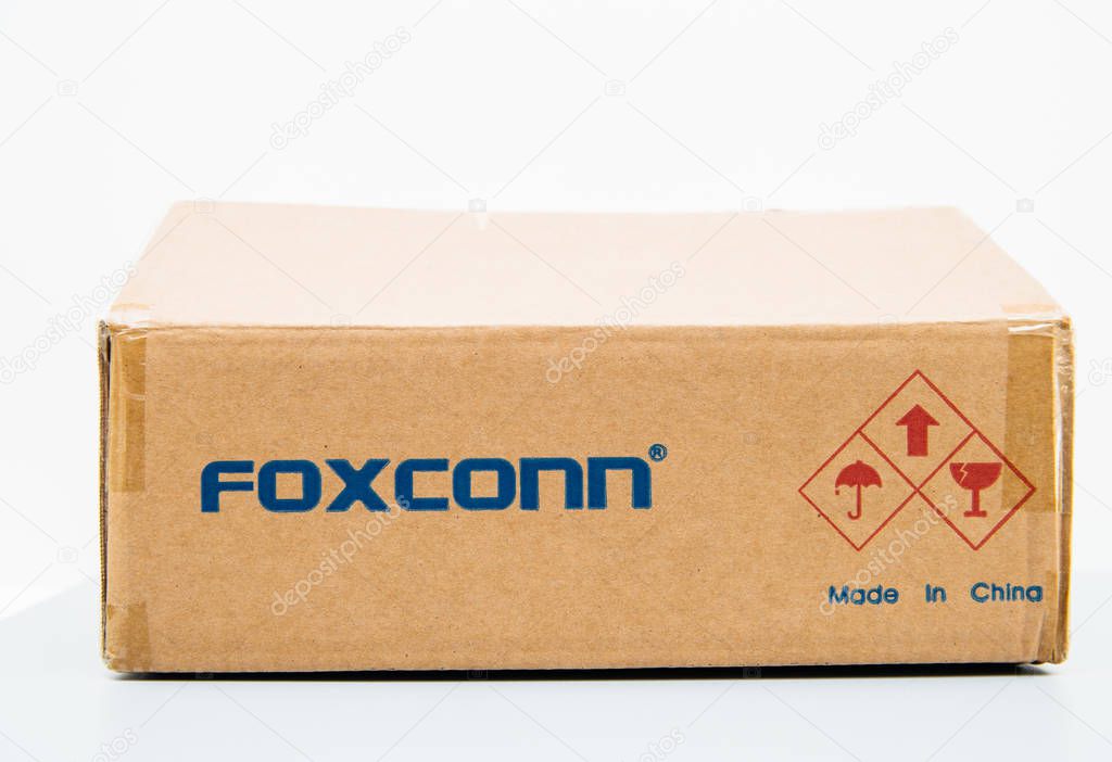 LONDON, UNITED KINGDOM - AUG 23, 2018: Unboxing Front view of Foxconn cardboard delivery box with logotype on against white background containing spare parts for computers laptop and technology part -