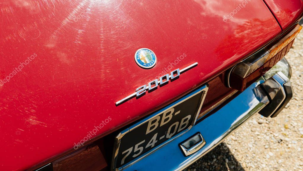 STRASBOURG, FRANCE - APR 30, 2018: View from above of vintage chrome insignia brand on the beautiful Red vintage luxury Alfa Romeo 2000 sport car parked on the street in France on a sunny day