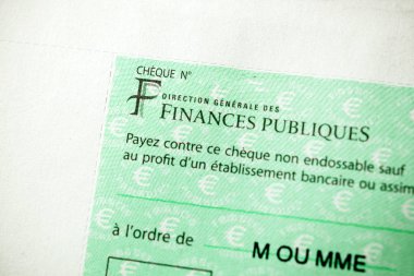 PARIS, FRANCE - JAN 1, 2015: Detail of French Cheque issued by the Direction Generale des Finances Publiques - the division of Economic Minister responsible for income taxes clipart