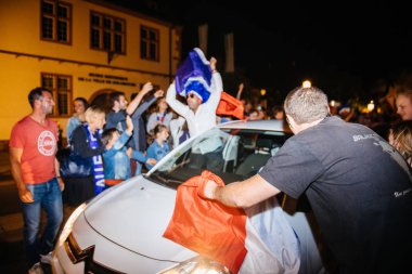 STRASBOURG, FRANCE - JULY 10, 2018: Man waving France flag from car Unique French celebration after the victory of France qualify for the final of the 2018 FIFA World Cup after their victory clipart
