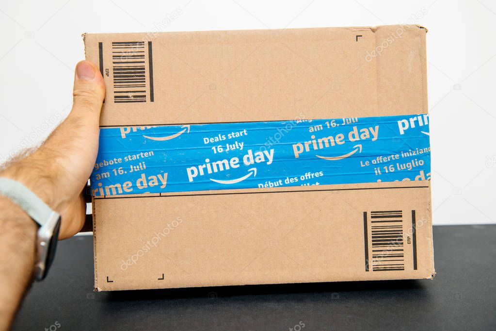 PARIS, FRANCE - JUL 12, 2108: Amazon Prime Day cardboard parcel with special blue scotch tape for the Prime Day offering a day of deals, discounts, and unabashed shopping