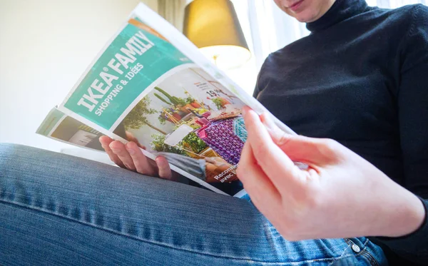 PARIS, FRANCE - MAY 3, 2017: Elegant woman reading IKEA catalogue furniture choosing for her new house — Stock Image Paris France May 2017 Elegant Woman Reading Ikea Catalogue Furniture Royalty Free Stock Photos