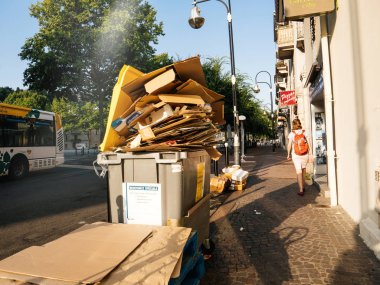 Chambery, Fransa - Aug16, 2018: Fransızca Chambery dumpsters kağıt karton kutuları çöp kadın yakın yürüyüş ile dolu olmak ile sokakta