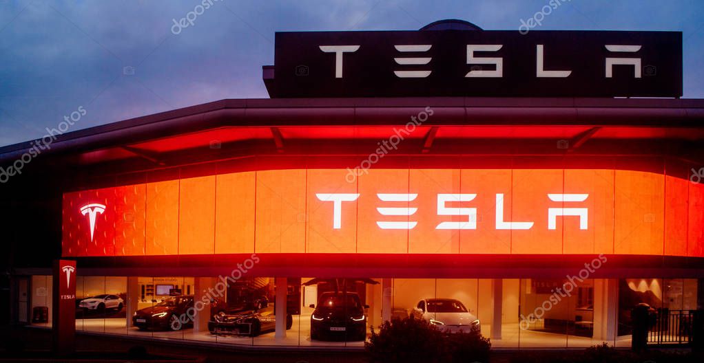 LONDON, UNITED KINGDOM MAR 8, 2017: Modern Tesla Motors showroom with multiple luxury Tesla cars inside at sunset in central London