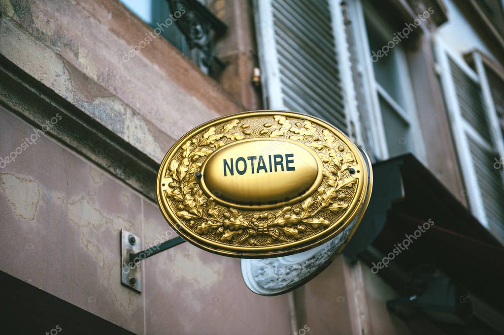 Notaire sing on wall above entrance to the notary office