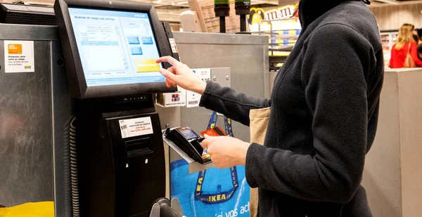 Mulher usando touchscreen digital para pagar por produtos — Fotografia de Stock