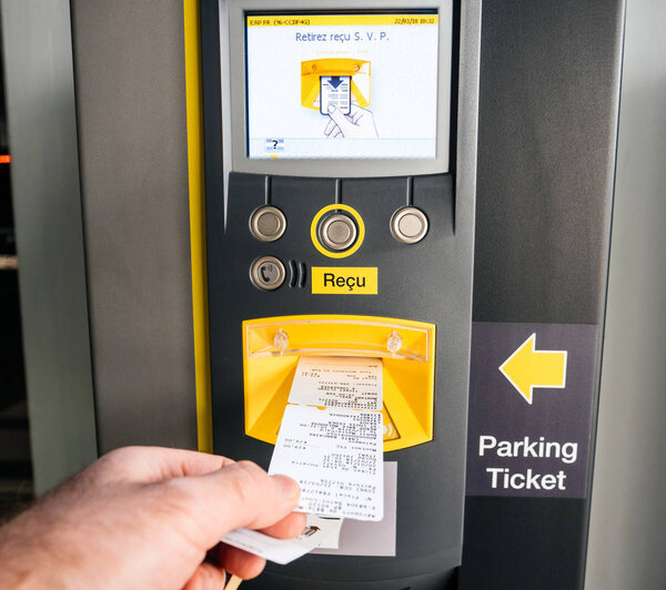 Taking ticket and invoice out from parking machine