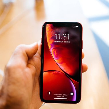 Paris, Fransa - 26 Ekim 2018: sıvı Retina ile yeni smartphone vasıl denize indirmek gün pov sırasında Apple Store bilgisayarlara en son kırmızı iphone Xr smartphone tutan adam el 