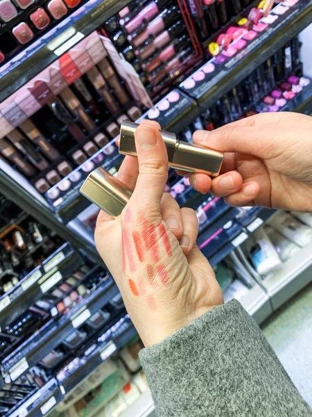 Woman shopping lipstick cosmetics