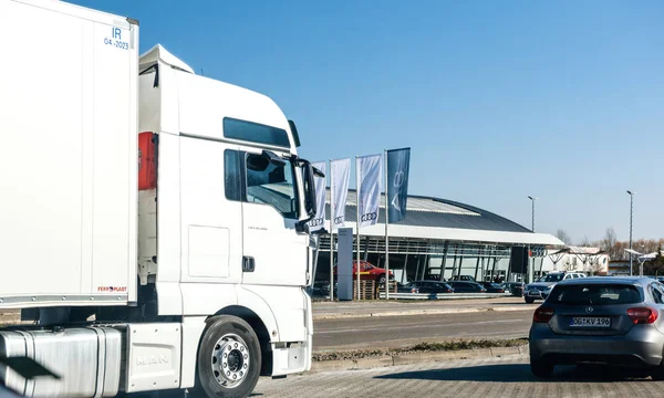 Audi car dealership in Germany view through truck and cars