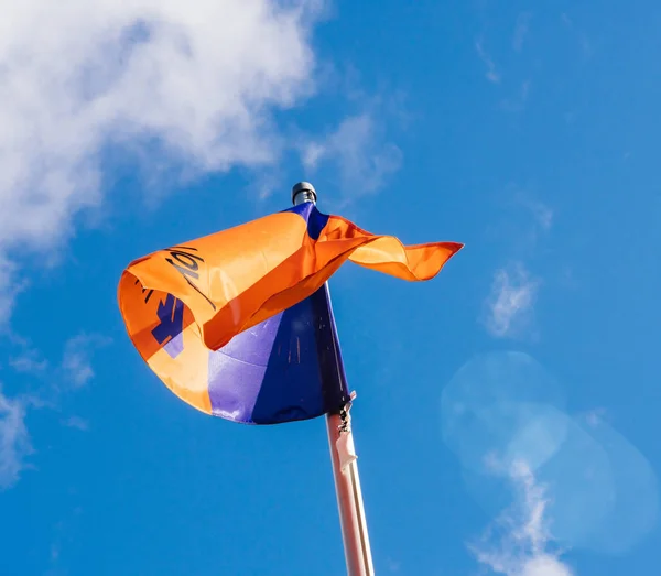 Hapag-Lloyd flag waving against blue sky — Stock Photo, Image