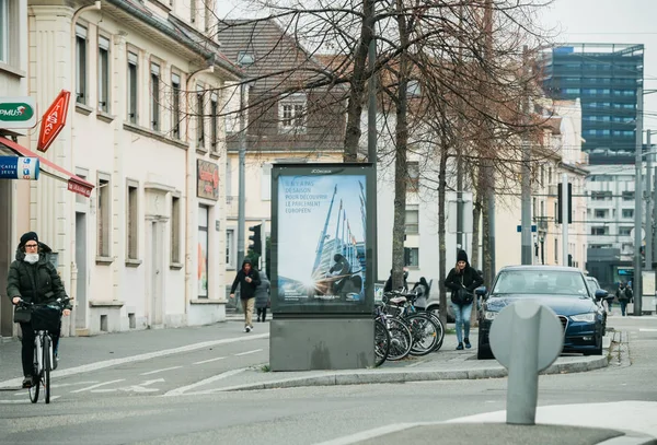 Pedestrians walking on a French street near advertising banner — Stock Photo, Image