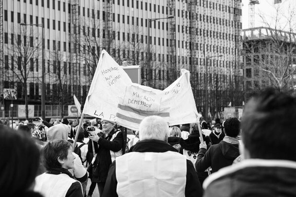 Placard with inscription Macron Demission at yellow vests protest