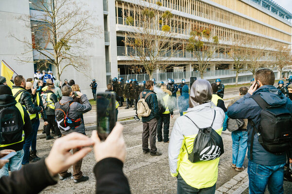 Man with mask taking photo at protest in France