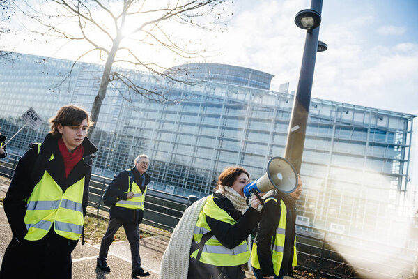 Woman yelling on megaphone protest France