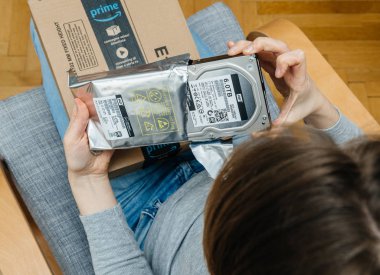 Woman unpacking unboxing Amazon Prime cardboard box HDD clipart