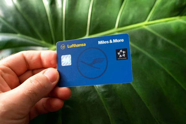 Male hand holding Miles and More membership Lufthansa card — Stock Photo, Image