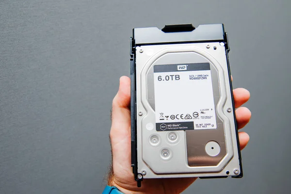 Male hand holding 6tb disk drive upgrade — Stock Photo, Image