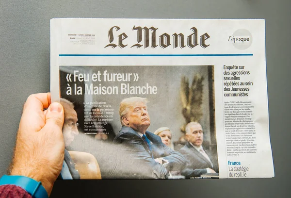 Hombre sosteniendo el periódico Le Monde con Donald Trump — Foto de Stock
