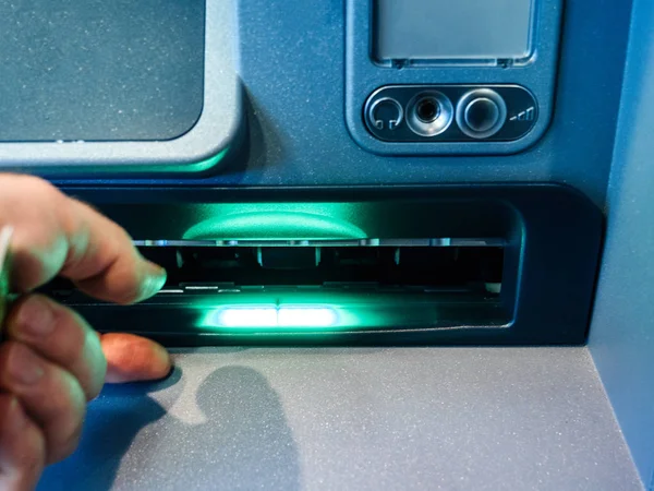 Male hand waiting for money from the withdrawal slot of modern ATM — Stock Photo, Image