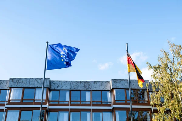 European Union blue flag and German flag waving in front Court — Stock Photo, Image