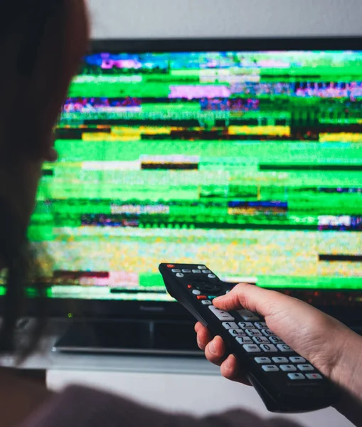 Mulher com controle remoto em busca de bom sinal na tv — Fotografia de Stock