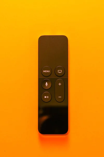 Apple TV remote on yellow background — Stock Photo, Image