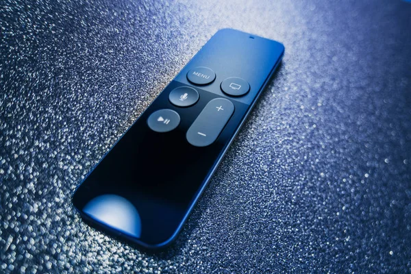 Apple TV 4k Remote control sparkly blue background — Stock Photo, Image
