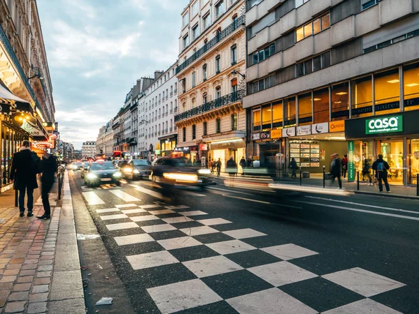 Cass Fußgänger und Pariser Gebäude in der Dämmerung auf der rue saint-lazare — Stockfoto