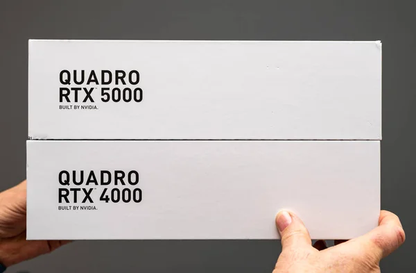 Senior man holding cardboard box of new Nvidia Quadro RTX cards — Stock Photo, Image