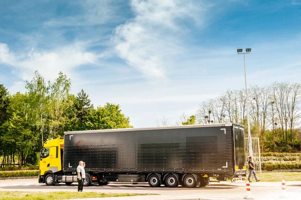 Driver near new Yellow Renault truck in cargo parking — Stock Photo, Image