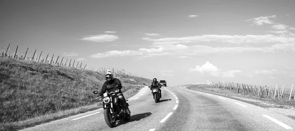 За двумя мотоциклистами следует черный внедорожник на дороге — стоковое фото