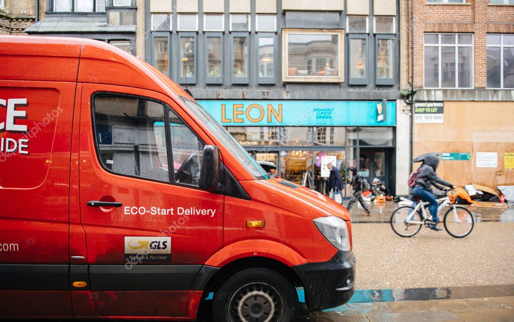 Oxford, United Kingdom - Mar 3, 3017: Front view of part of GLS Partner Parcel Force Delivery Parcel red van in front of Leon restaurant