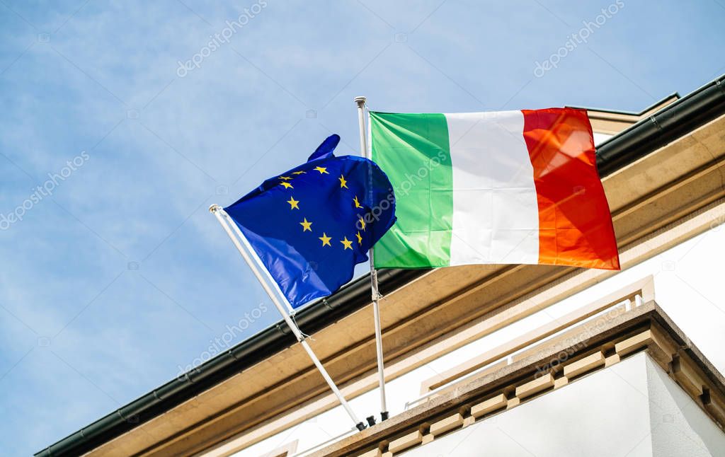 The European flag of Europe and Italian flag waving low angle view