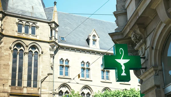 Vintage green pharmacy sign on a Hausmannian building