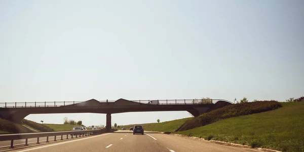 Driver POV at highway with bridge over the multiple lanes — Stock Photo, Image