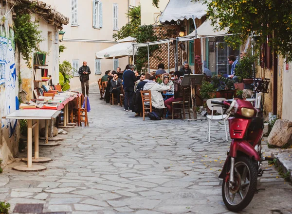 食べ物のストリートレストランを楽しむ人々と小さなかわいいギリシャの通り — ストック写真