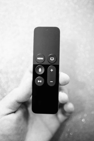 Man hand holding modern Apple TV 4k remote control — Stock Photo, Image