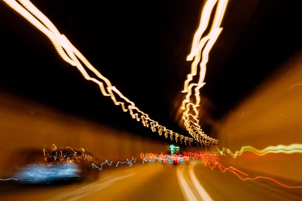 Cars driving fast inside closed tunnel trails — Stock Photo, Image