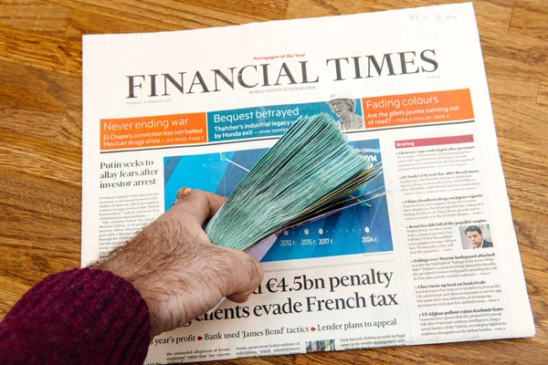 Man hand holding stack pile money currency Financial TImes — Stock Photo, Image
