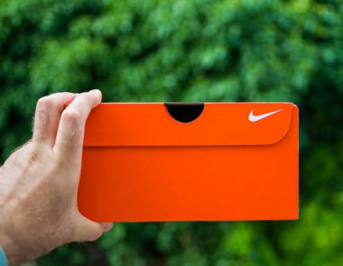 Adam el yeşil parka karşı yeni Nike karton kutu tutan