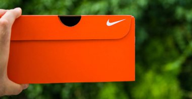 Adam el yeşil parka karşı yeni Nike karton kutu tutan