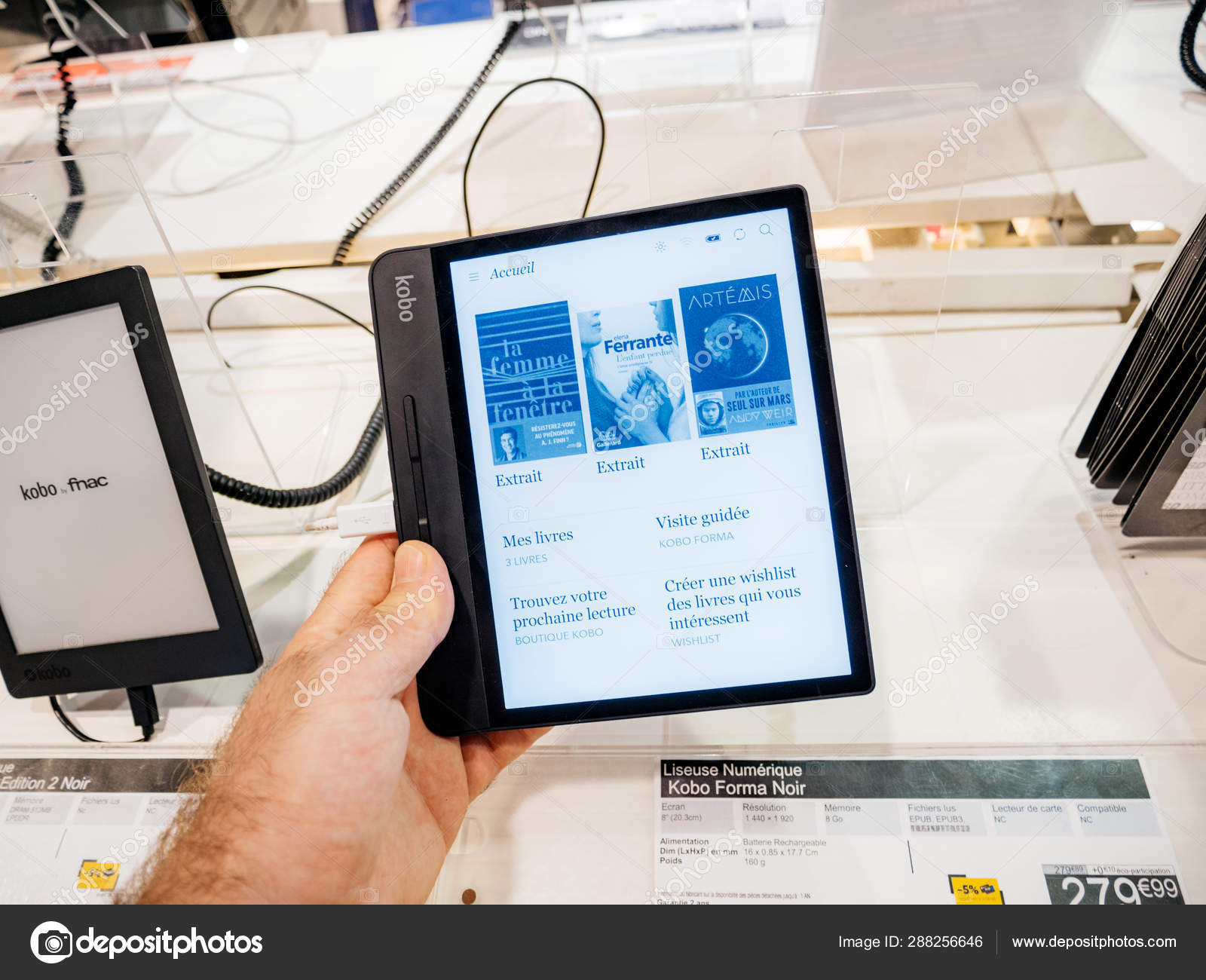 Man hand holding Kobo Forma e-reader book in Fnac – Stock