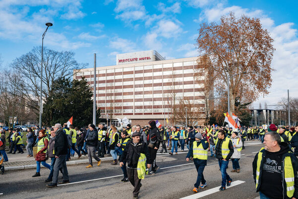Protesters with Mercure Accor hotel in background