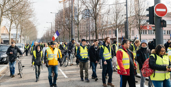Placard with inscription Macron Demission at yellow vests protest
