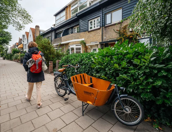 Woman walking on Dutch street rear view — Stock Photo, Image