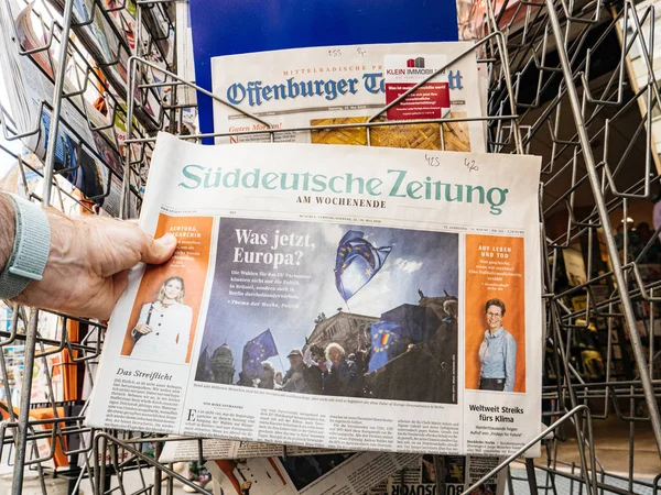 Man hand POV läsning på press kiosk Suddeutsche Zeitung — Stockfoto